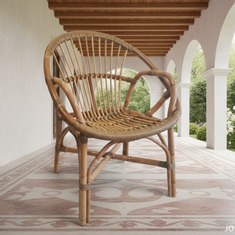 Wicker rattan chair on a tiled porch with white arches and a lush garden in the background.