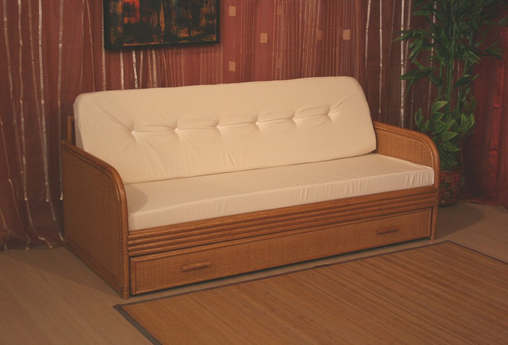IMG3243gra jollygiuncoeu wicker framed sofa with white cushions in a living room with a potted plant on the right and red curtains in the background