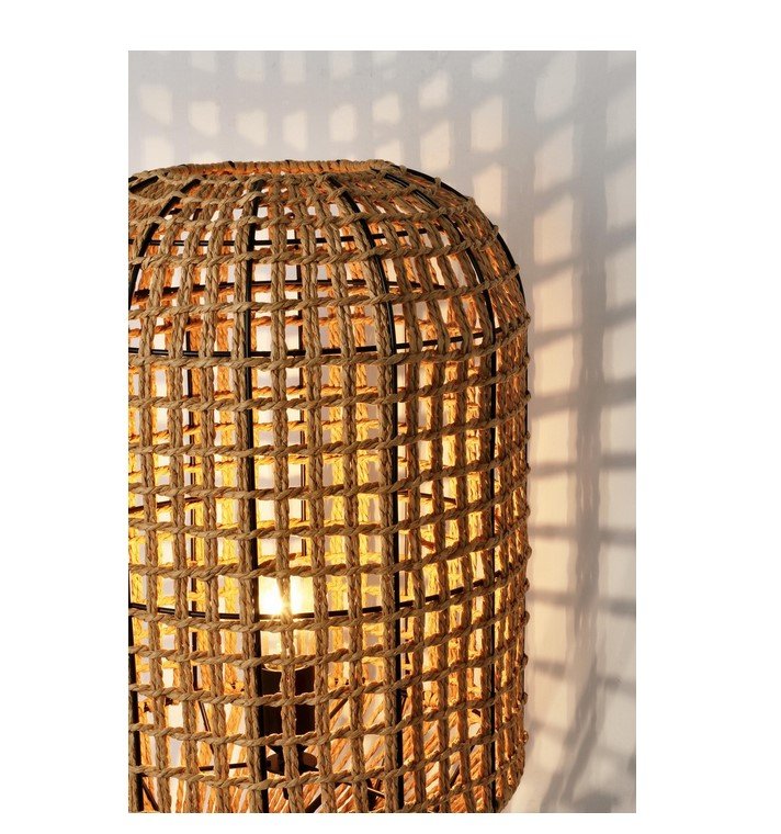 PIANTANA MALABO NATURALE H1352 jollygiuncoeu woven rattan lamp glowing warmly casting geometric shadows on the wall behind it