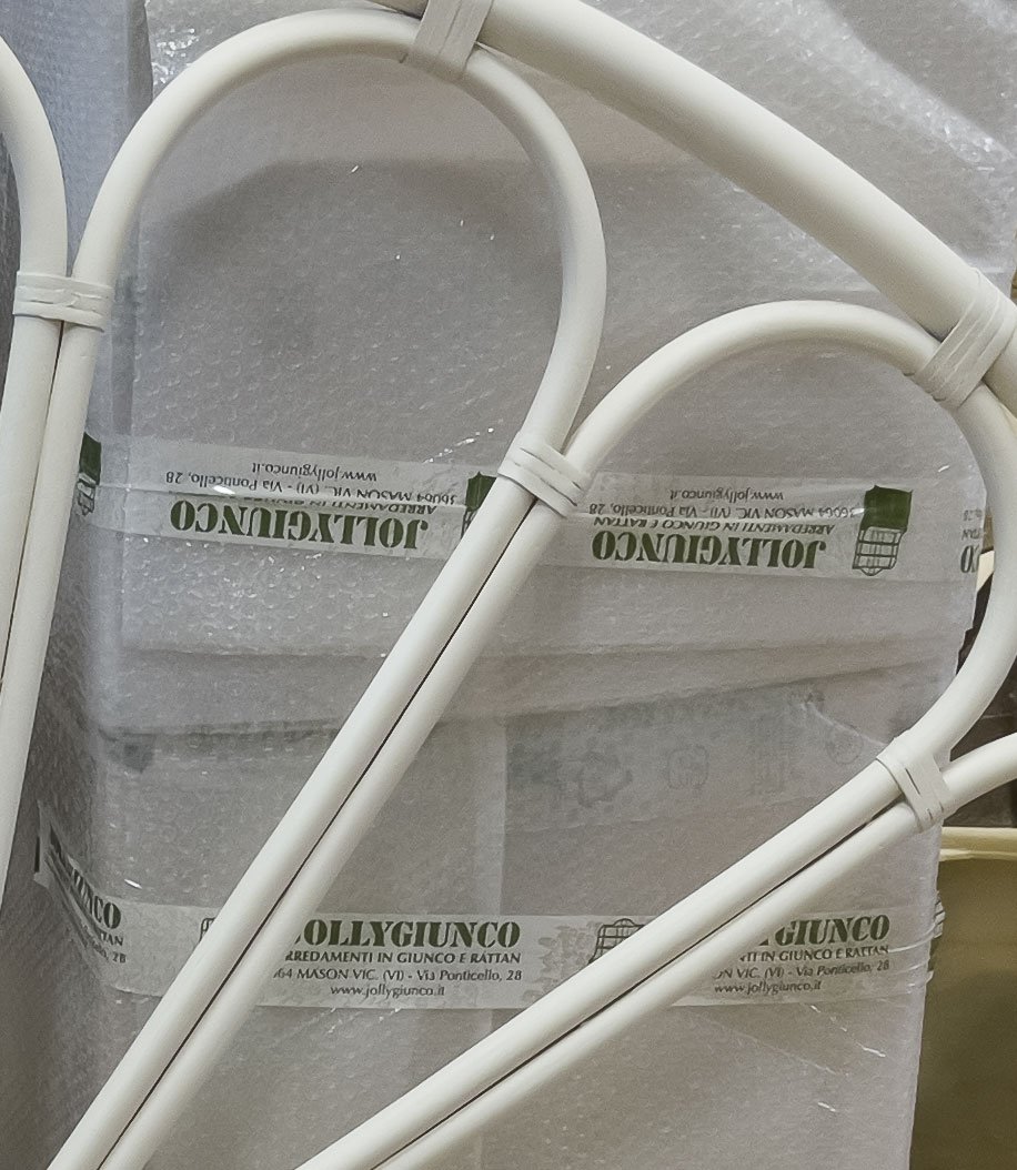LettoMargheritaMatrimoniale jollygiuncoeu close up of white plastic coated cables tied with zip ties on bubble wrap packaging surface with tape showing the brand name