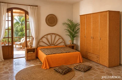 Bedroom with orange bedspread, round rug, leopard cushions, wicker wardrobe, and a potted palm; French doors open to a sunny balcony.