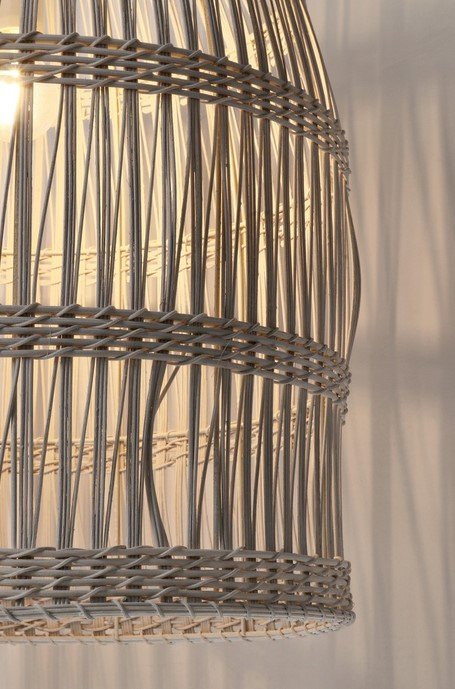 LAMPADARIO PRAIA BIANCO H67 3 jollygiuncoeu woven pendant lamp with a warm glow showing intricate braided rattan strands forming circular bands around a cylindrical shade on a wall