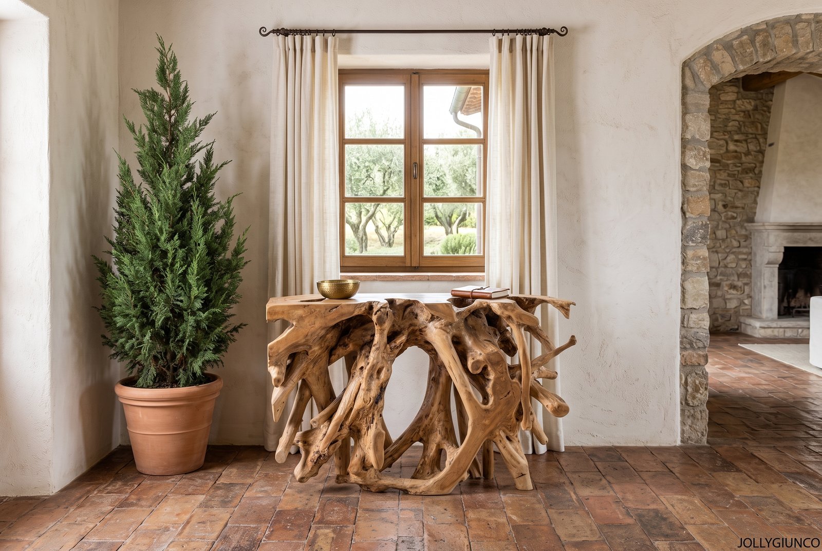 CONSOLLE SOLIDAD 120X40 11 jollygiuncoeu rustic living area with a carved wooden console table tall potted evergreen and a window with beige curtains stone arch and fireplace to the right