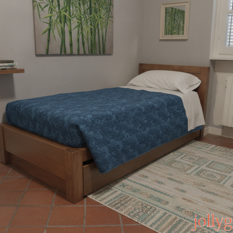 Single wooden bed with a blue patterned comforter and white pillow in a small bedroom with a rug and window visible.
