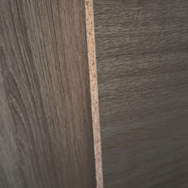Close-up of two dark wood panels joined by a narrow vertical light plywood edge.